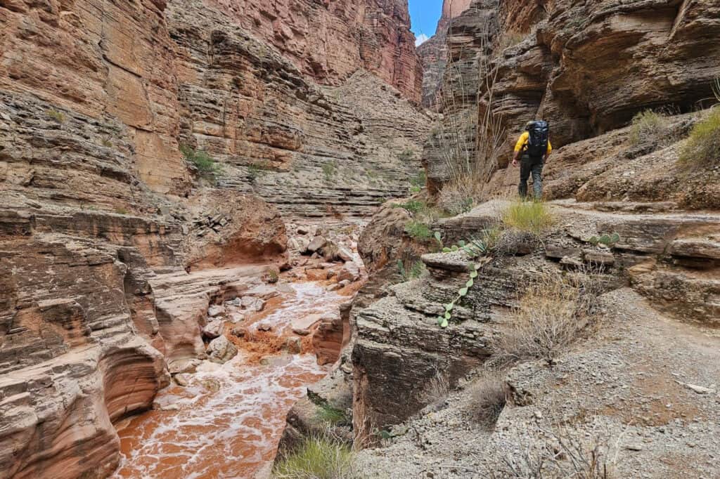 In a US NPS photo, a search team looks for a woman missing in a flash flood near the confluence of Havasu Creek and the Colorado River