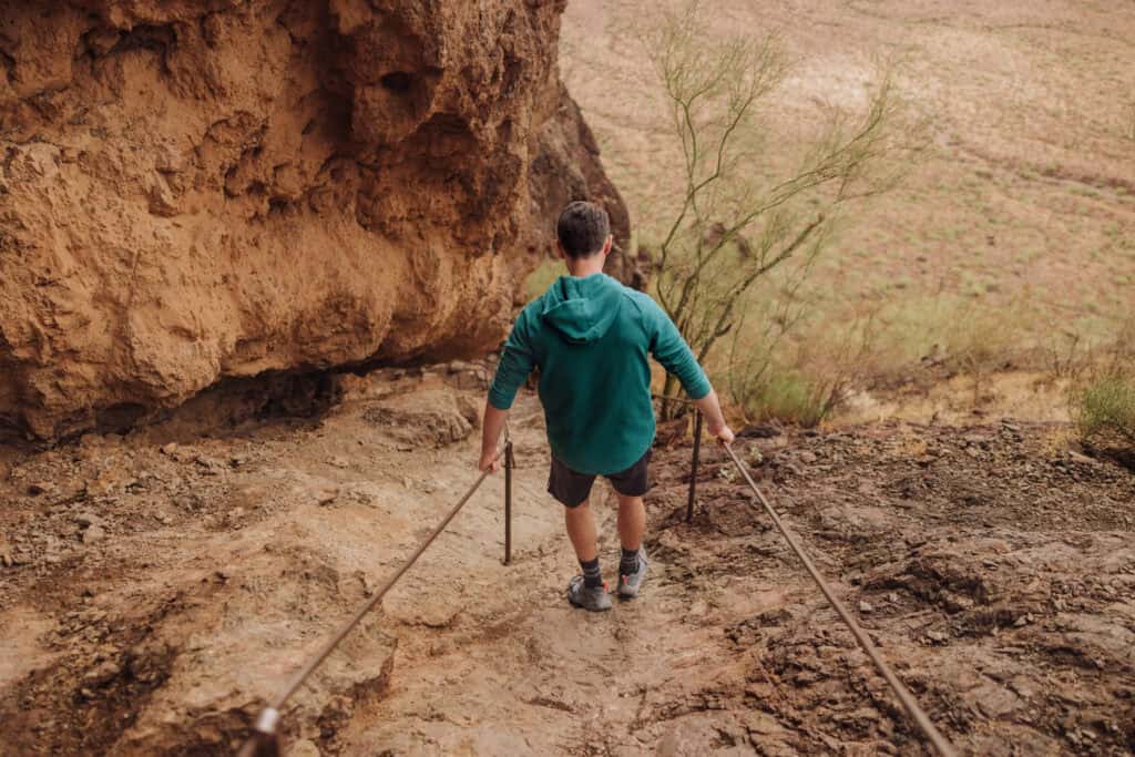 Jared Dillingham using the cables on the Picacho Peak hike