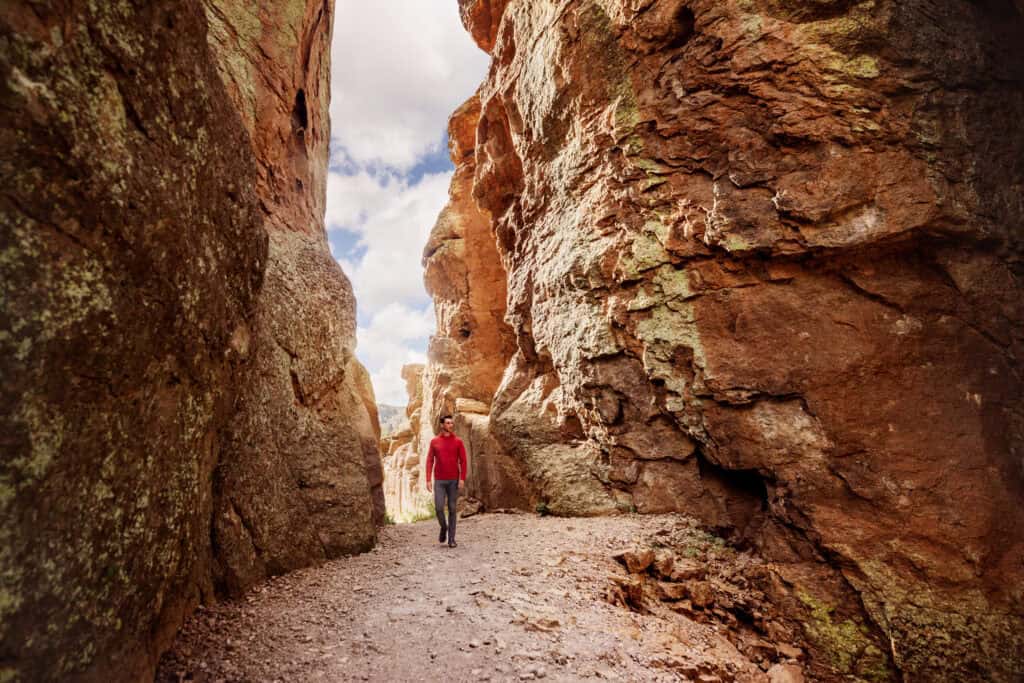 Jared Dillingham walking through the Grottoes at Chiricahua