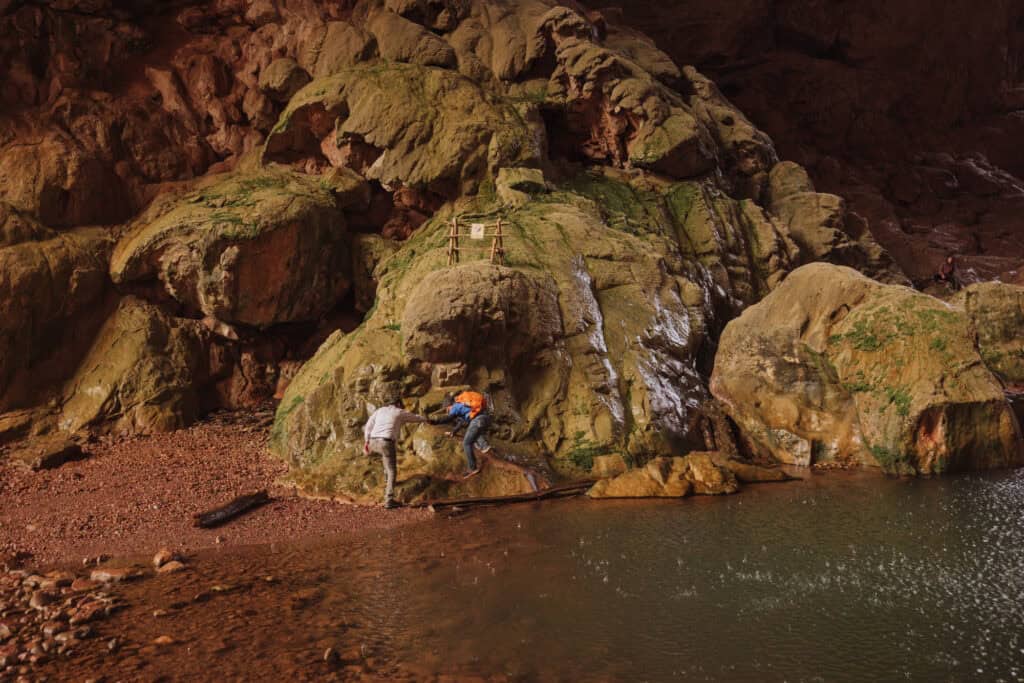 Climbing rocks to hike under Tonto Natural Bridge