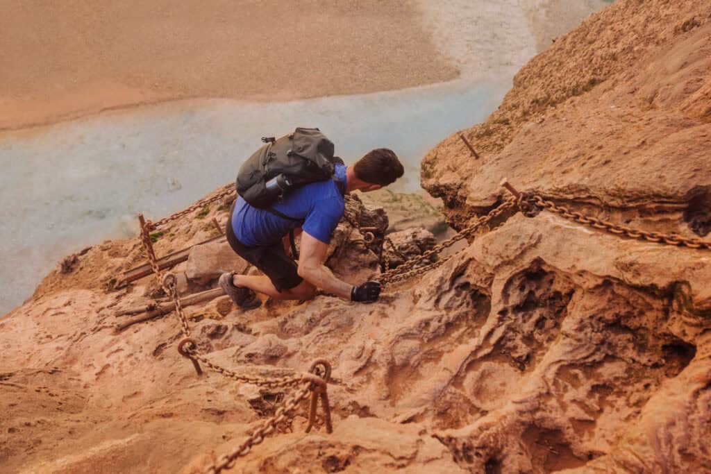 Using the chains to climb down Mooney Falls