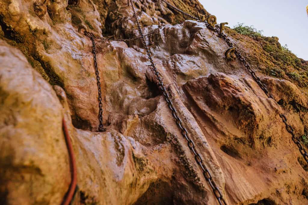 The chains, anchored into the rock on the descent down Mooney Falls