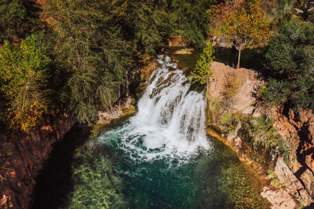 An aerial drone view of the waterfall at Fossil Creek