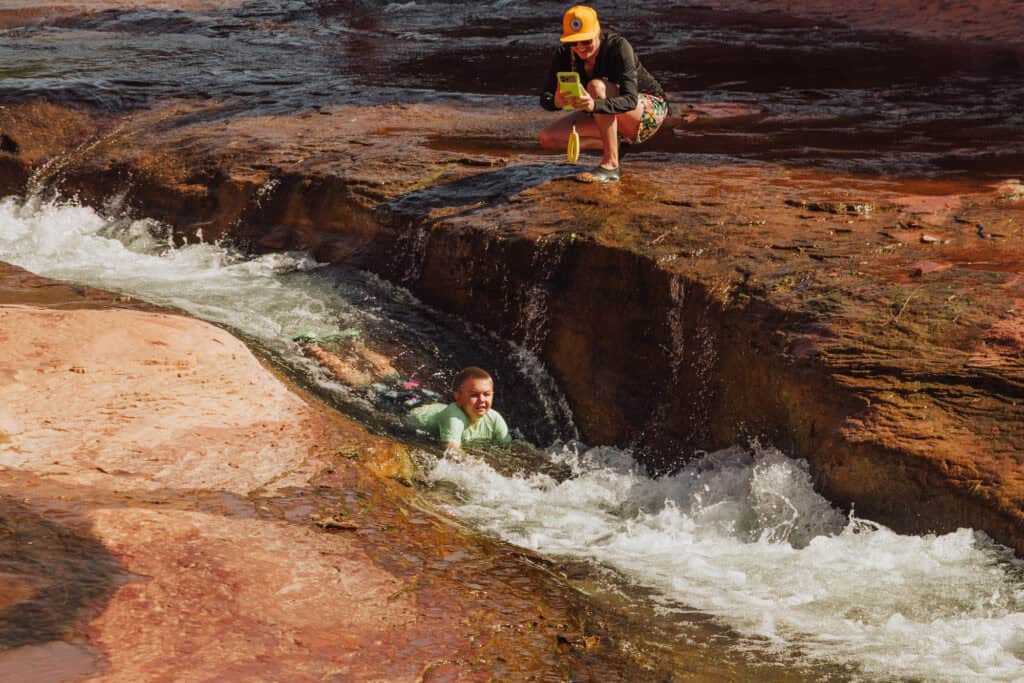 A kid swimming at Slide Rock along Oak Creek in Sedona